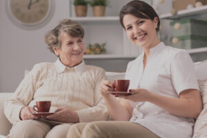 Image of private caregiver and senior female smiling